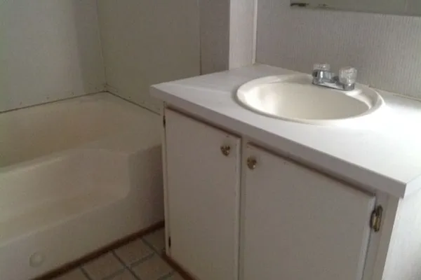 a bathroom with a sink and mirror