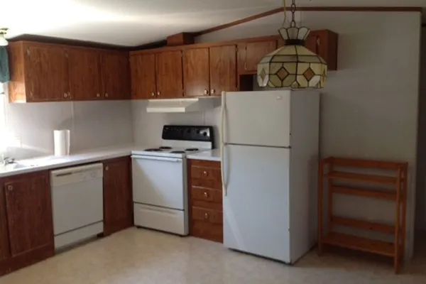a kitchen with a refrigerator and a stove