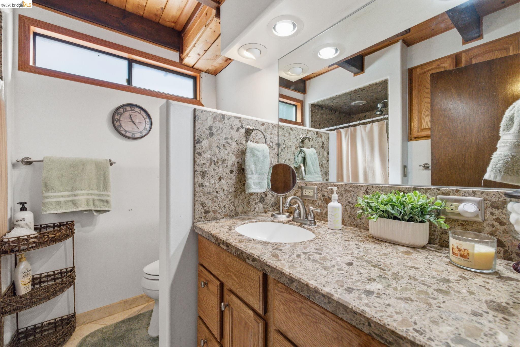 22555 South Fork Road Sonora, CA 95370 - Photo 9 of 35 a bathroom with a granite countertop sink a large mirror and shower