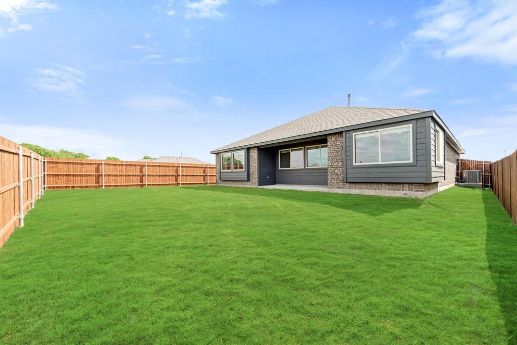920 Elk Ridge Run Godley, TX 76044 - Photo 27 of 34 Expansive green lawn with a full wood privacy fence