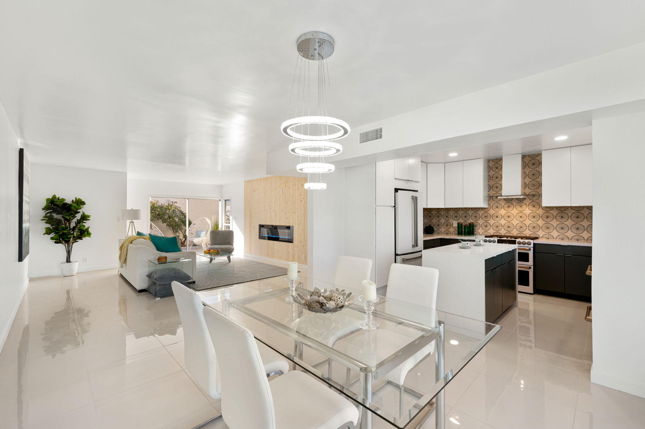 a living room with kitchen island furniture and a chandelier