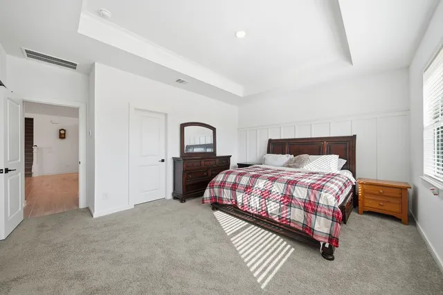 a bedroom with a bed and a mirror