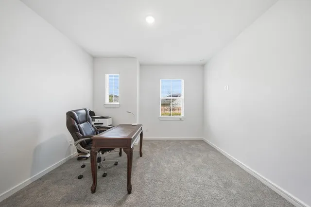 a workspace with furniture and window