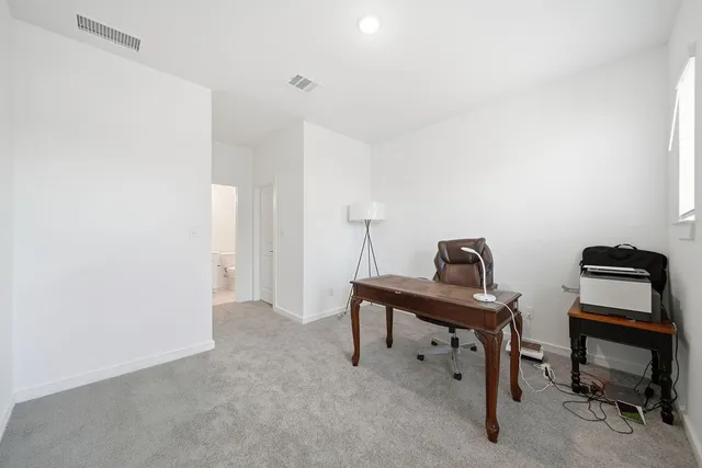 a view of a workspace with furniture