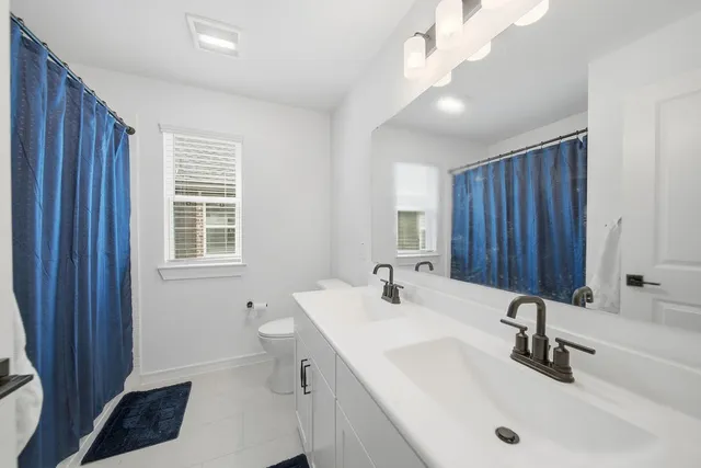 a bathroom with a sink and a large mirror