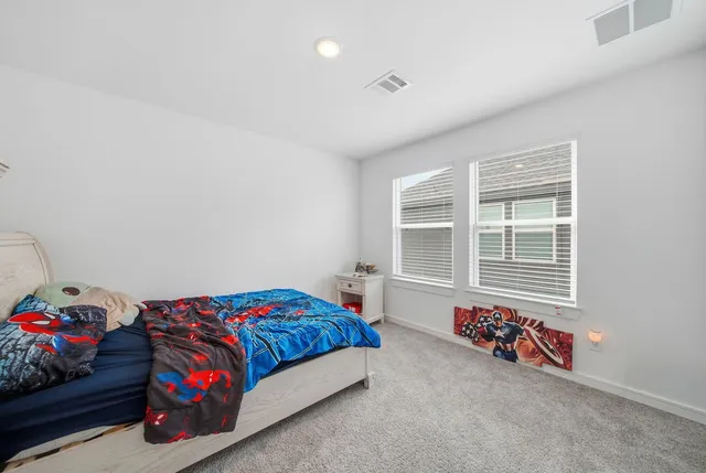 a bedroom with bed and a window