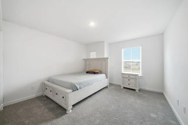 a room with a bed and a window