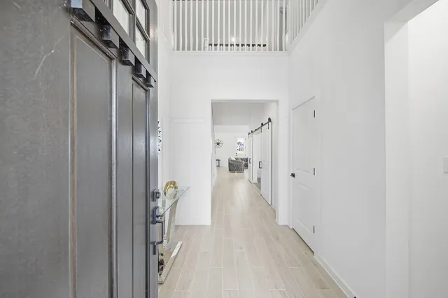 a view of hallway with wooden floor