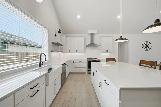a kitchen with cabinets a sink and appliances