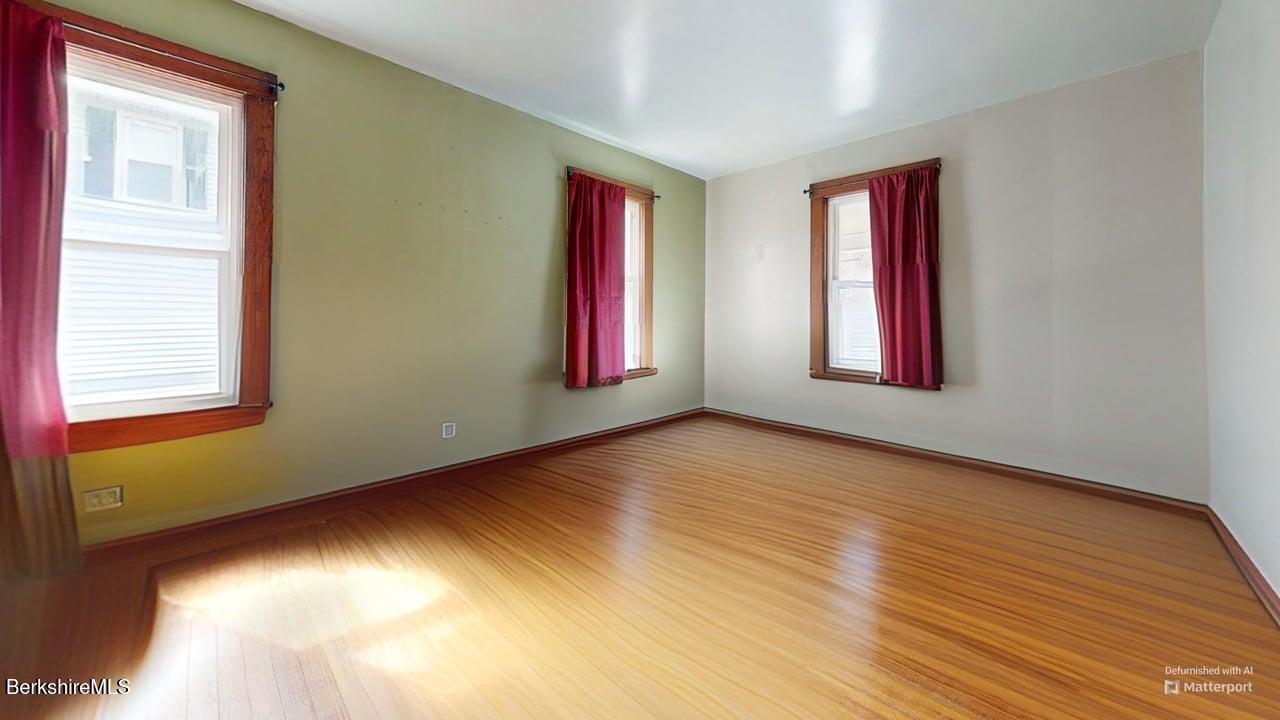 28 Upton Street Adams, MA 01220 - Photo 11 of 29 a view of an empty room with wooden floor and a window