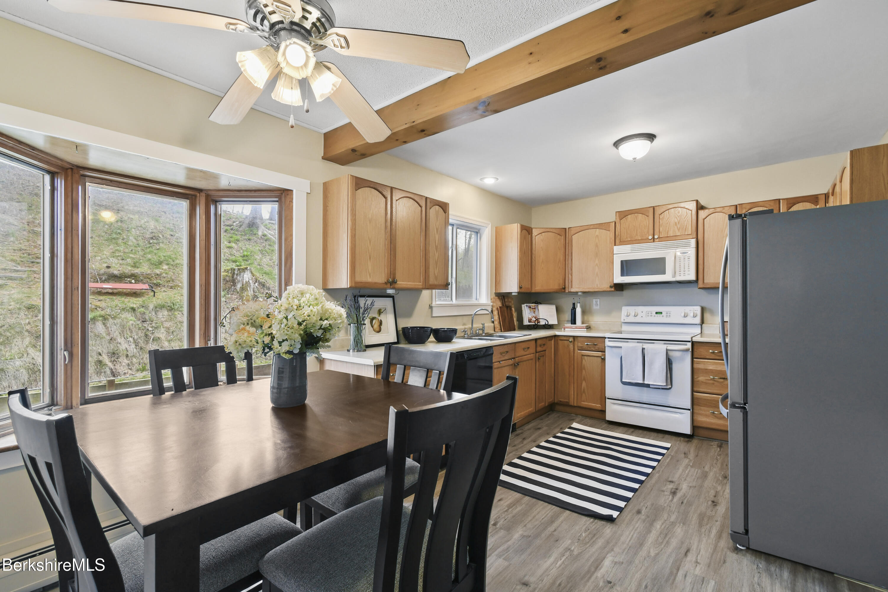 28 Upton Street Adams, MA 01220 - Photo 6 of 29 a kitchen with a dining table chairs stainless steel appliances and cabinets