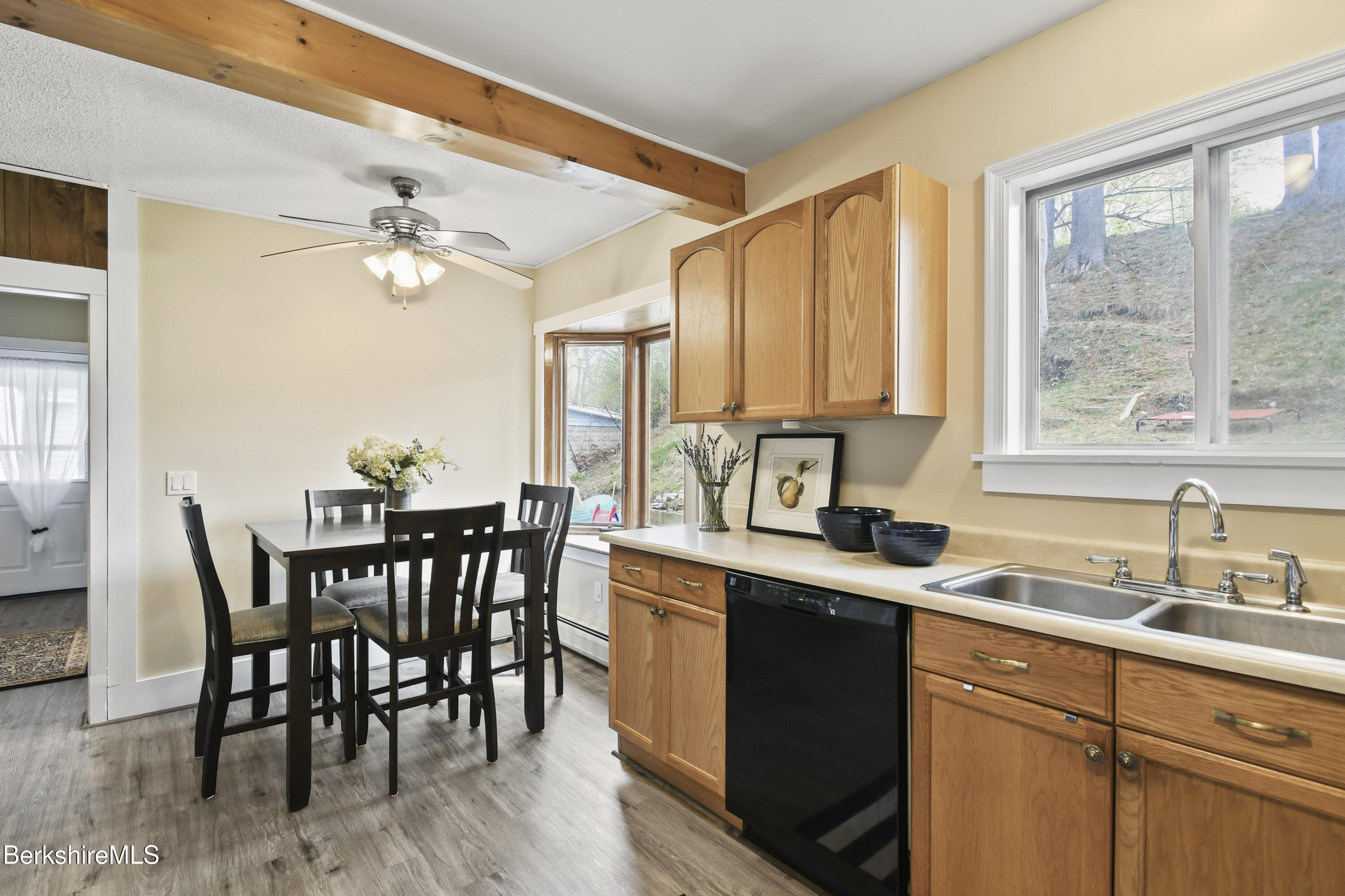 28 Upton Street Adams, MA 01220 - Photo 8 of 29 a kitchen with a table chairs sink and cabinets