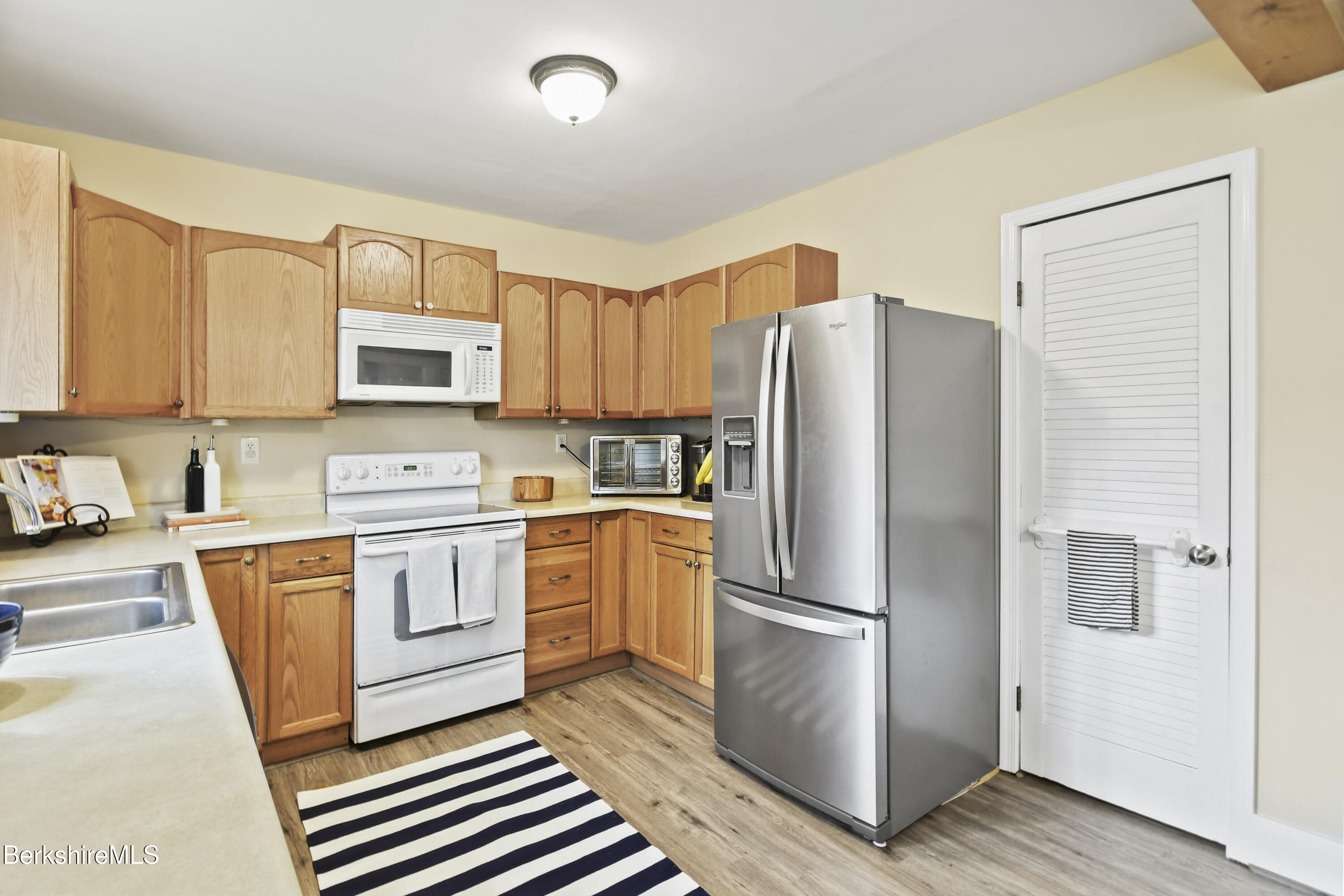 28 Upton Street Adams, MA 01220 - Photo 9 of 29 a kitchen with stainless steel appliances a refrigerator sink and microwave