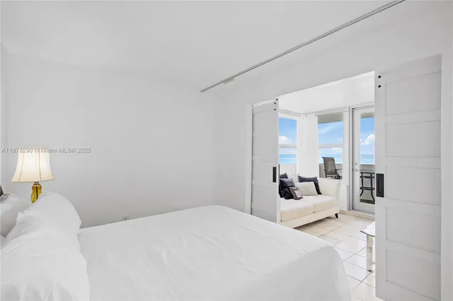 a bedroom with a bed and a large mirror