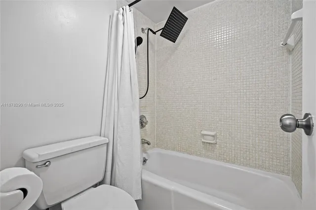 a bathroom with a toilet and a bathtub