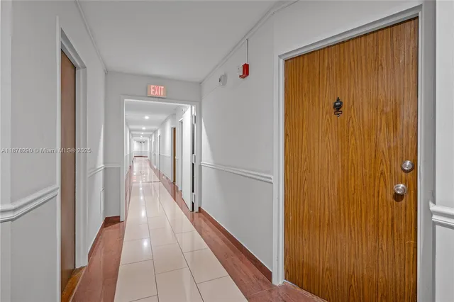a view of a hallway with wooden floor and closet area