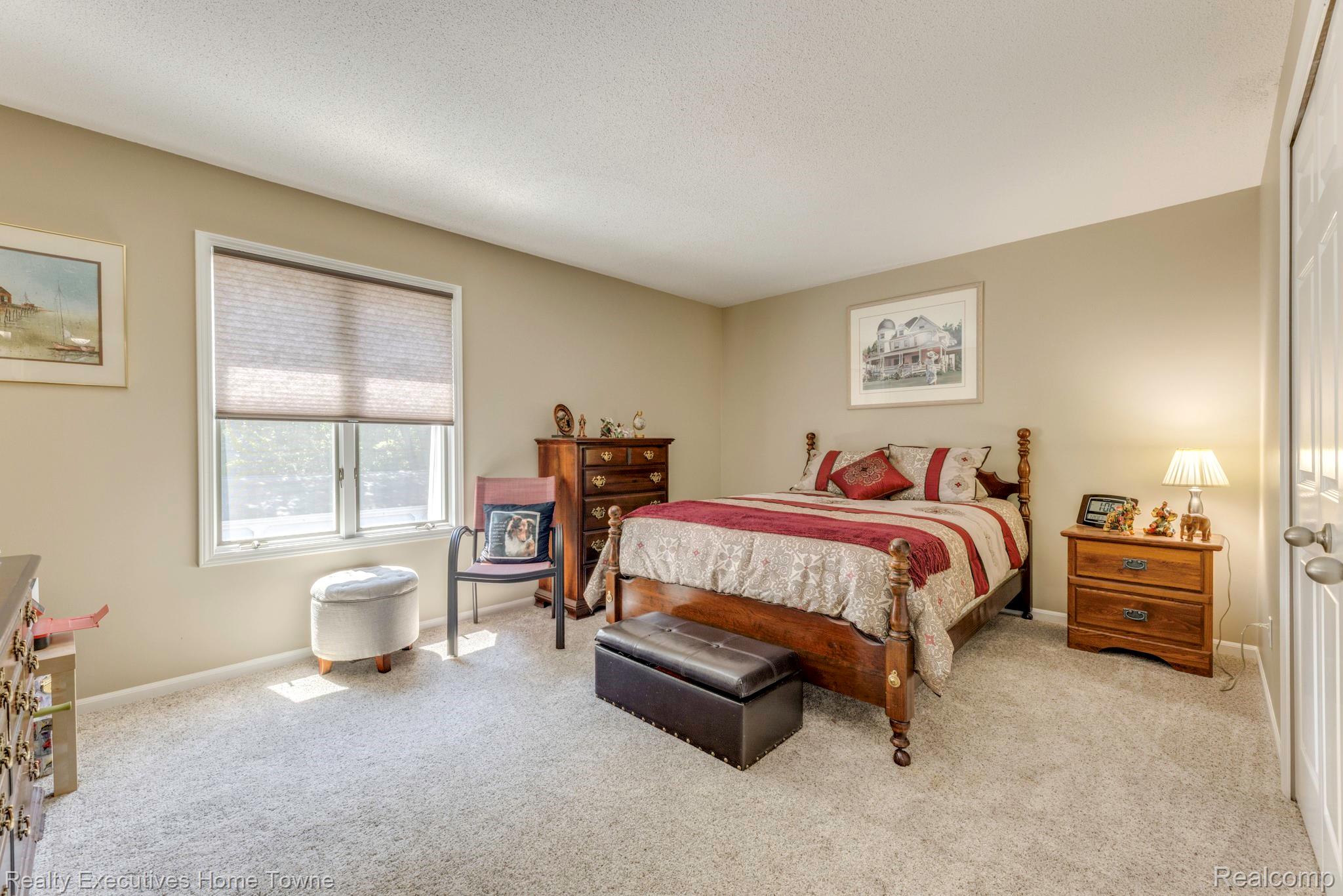 1467 Krafft Road, Unit 8 Port Huron, MI 48060 - Photo 20 of 30 Carpeted bedroom with a window featuring horizontal blinds, neutral wall paint, and a white paneled door