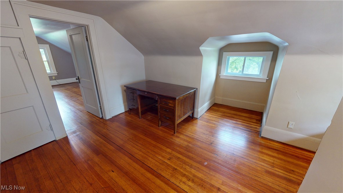 3261 Darrow Road Stow, OH 44224 - Photo 16 of 27 Additional living space with healthy amount of natural light, vaulted ceiling, light wood-type flooring, baseboards, and a baseboard heating unit