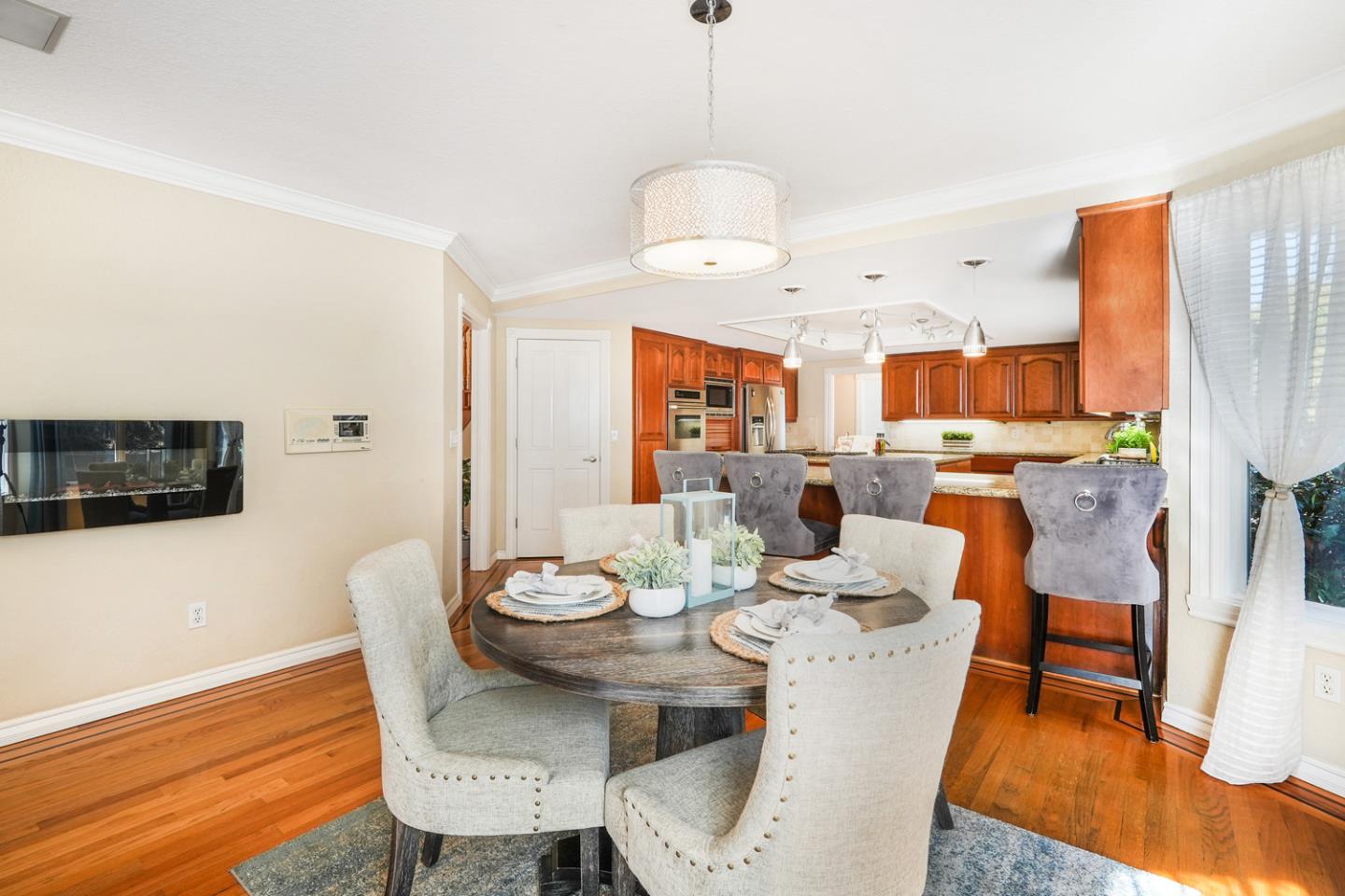 1245 Day Road Gilroy, CA 95020 - Photo 13 of 55 a view of a dining room with furniture wooden floor and a chandelier