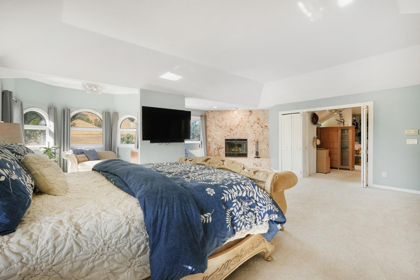 1245 Day Road Gilroy, CA 95020 - Photo 30 of 55 a spacious bedroom with a large bed and a flat screen tv
