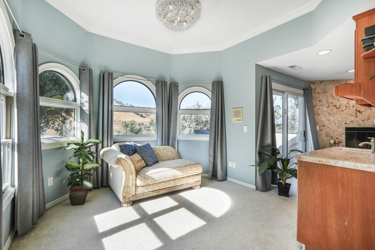 1245 Day Road Gilroy, CA 95020 - Photo 31 of 55 a living room with furniture a fireplace and a chandelier