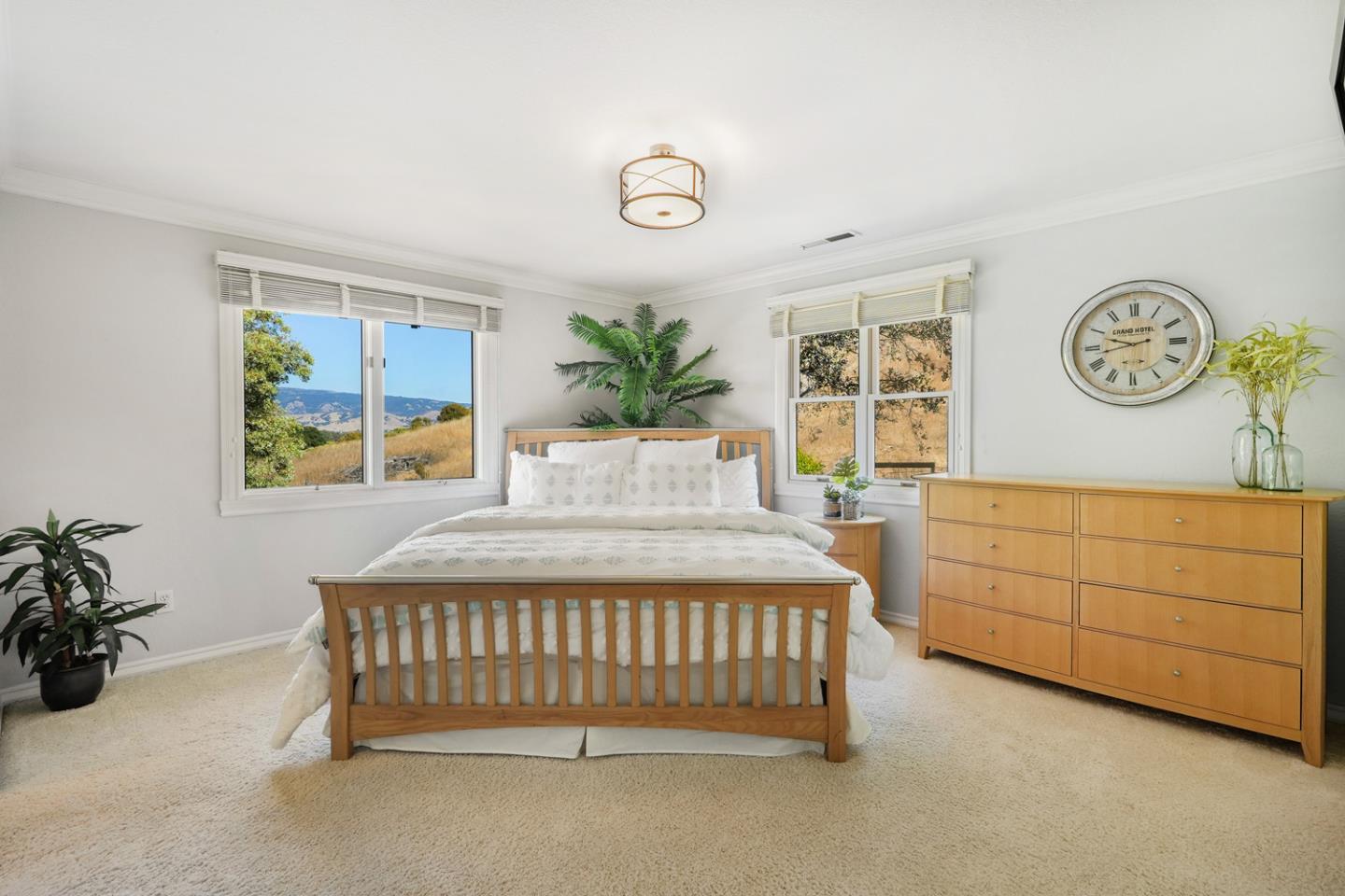 1245 Day Road Gilroy, CA 95020 - Photo 37 of 55 a bedroom with a bed a dresser and paintings on the wall