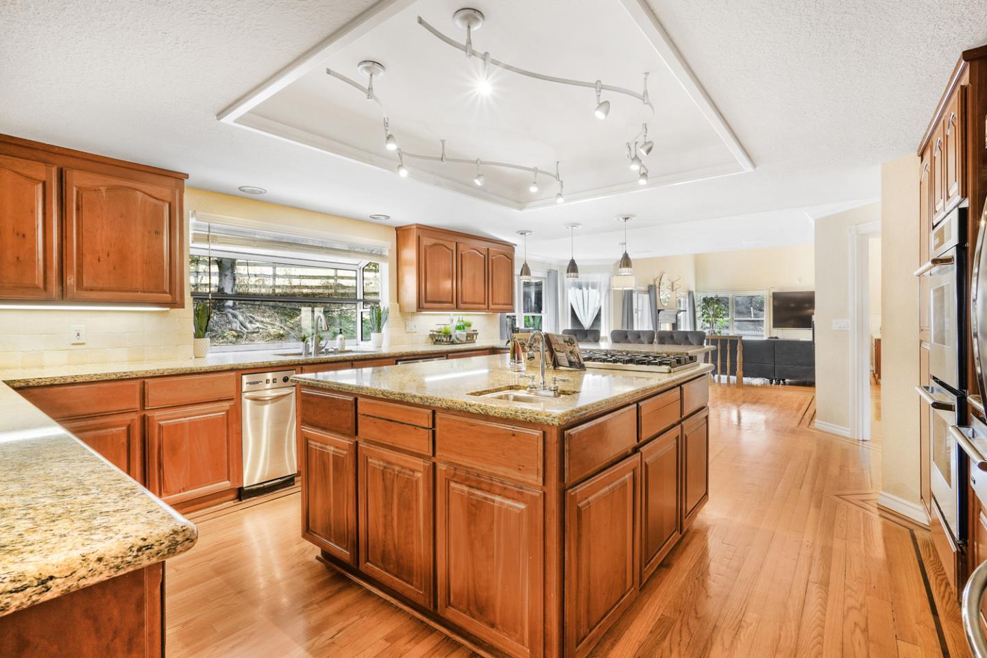 1245 Day Road Gilroy, CA 95020 - Photo 10 of 55 a large kitchen with stainless steel appliances granite countertop a lot of counter space and wooden floors