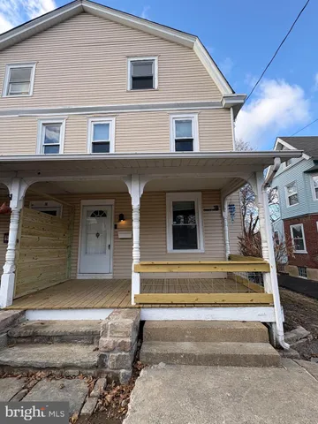 a view of a house front with chair and a ceiling fan