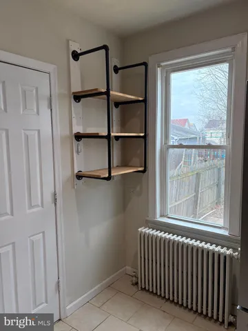 a view of a room with rack on the wall and a window
