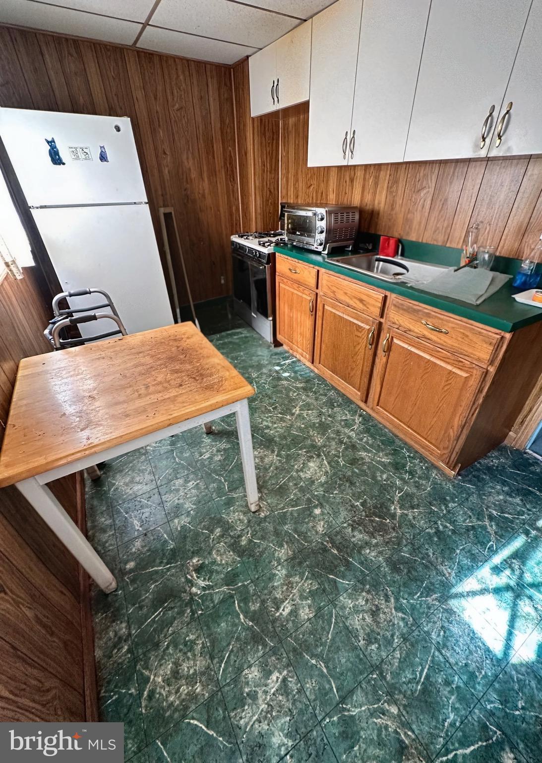 8019 Ryers Avenue Philadelphia, PA 19111 - Photo 5 of 10 a kitchen with stainless steel appliances kitchen island sink refrigerator and stove