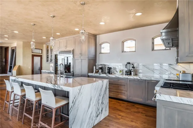 a large kitchen with lots of counter space and stainless steel appliances