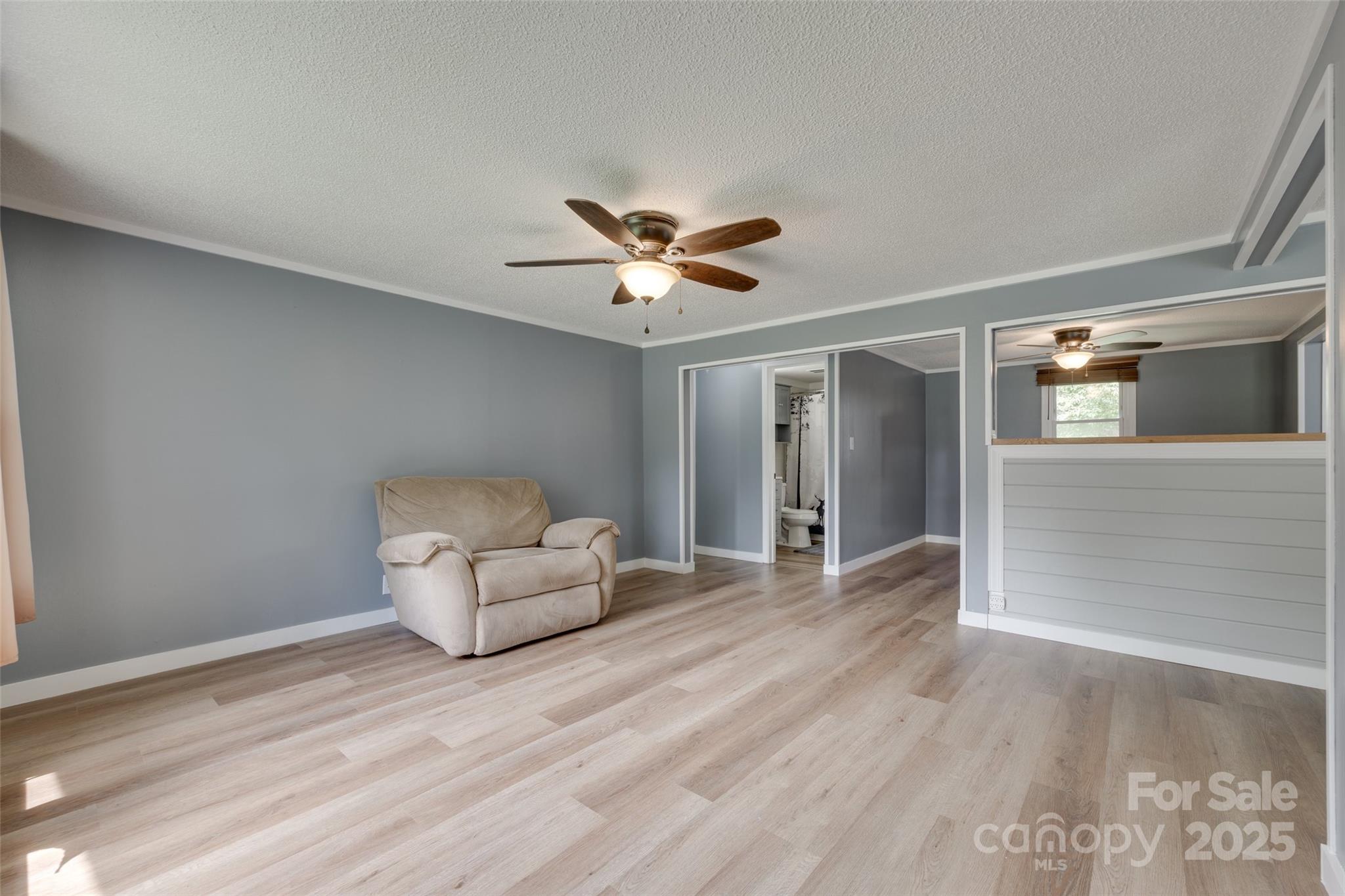 3083 State Rd S-11-54 Gaffney, SC 29340 - Photo 5 of 29 a view of an empty room with a ceiling fan and wooden floor