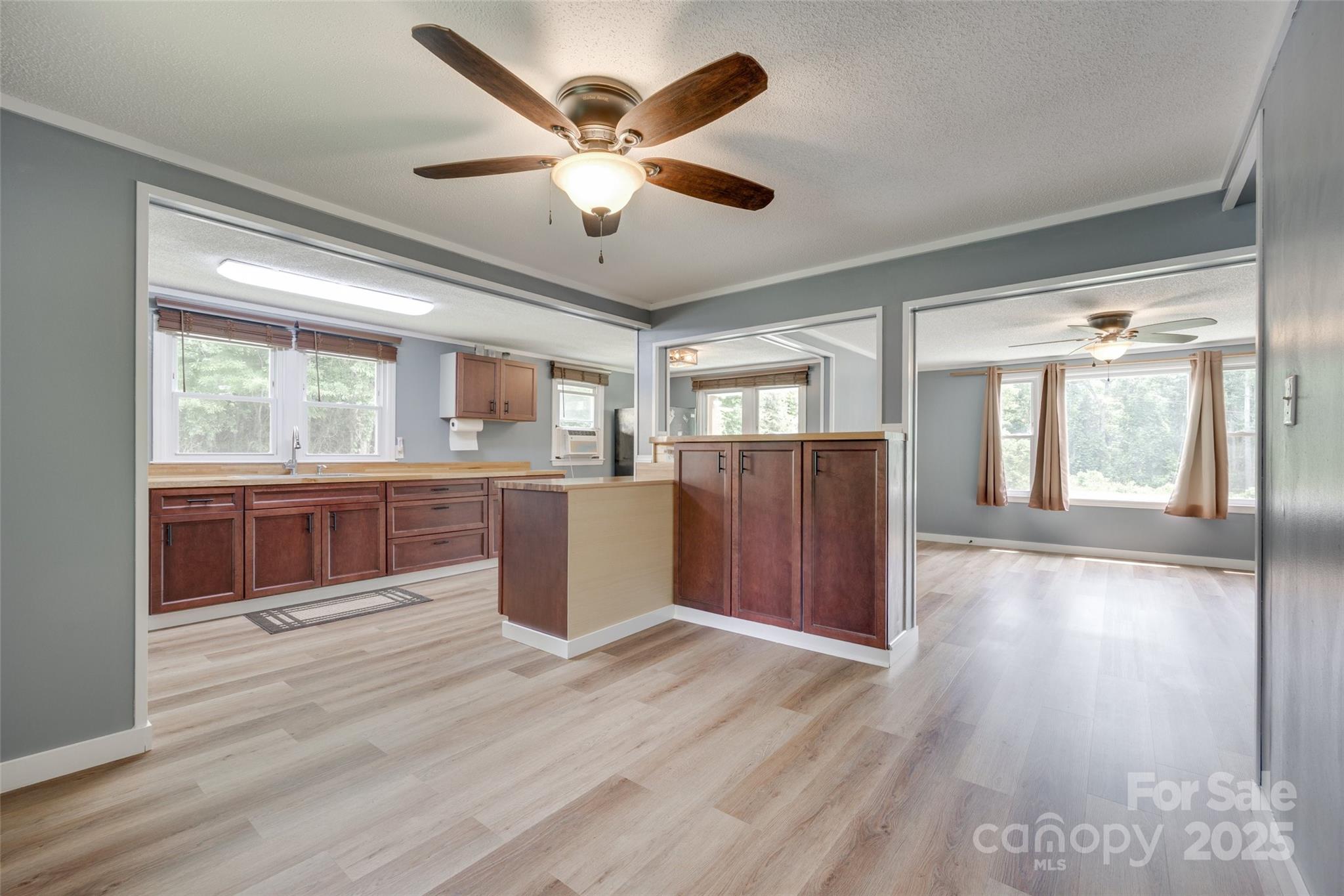 3083 State Rd S-11-54 Gaffney, SC 29340 - Photo 8 of 29 a view of a kitchen with a sink and wooden floor