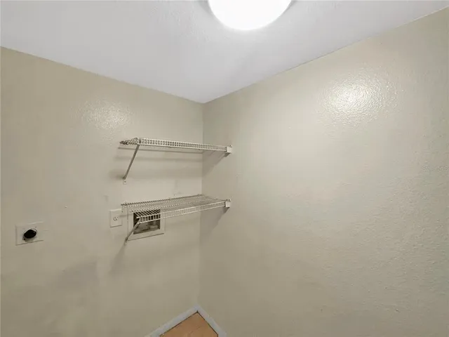 a view of a room with shelf on the wall