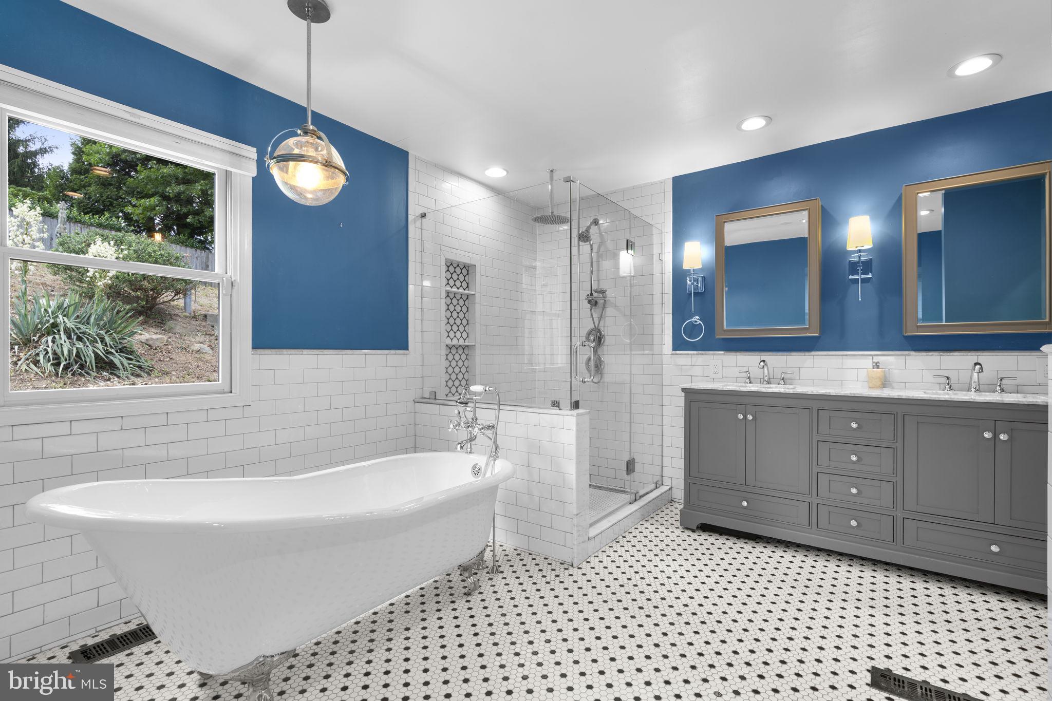 822 Loxford Terrace Silver Spring, MD 20901 - Photo 36 of 61 a bathroom with a bathtub a sink a window and a shower