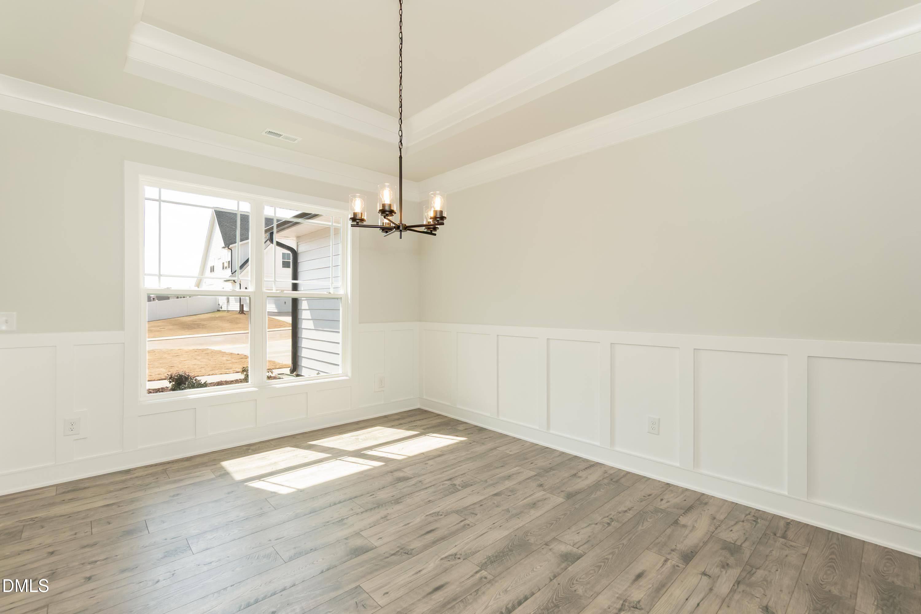 104 Galway Road Lillington, NC 27546 - Photo 9 of 40 a view of empty room with wooden floor and fan