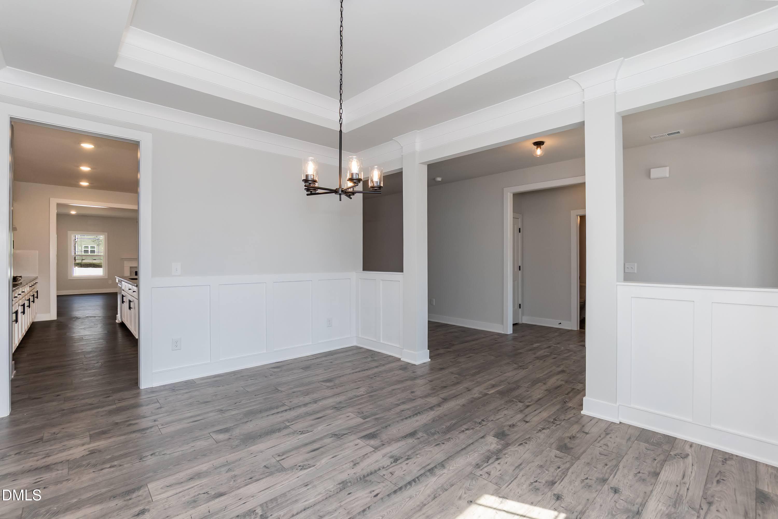 104 Galway Road Lillington, NC 27546 - Photo 10 of 40 a view of a livingroom with wooden floor staircase and a chandelier
