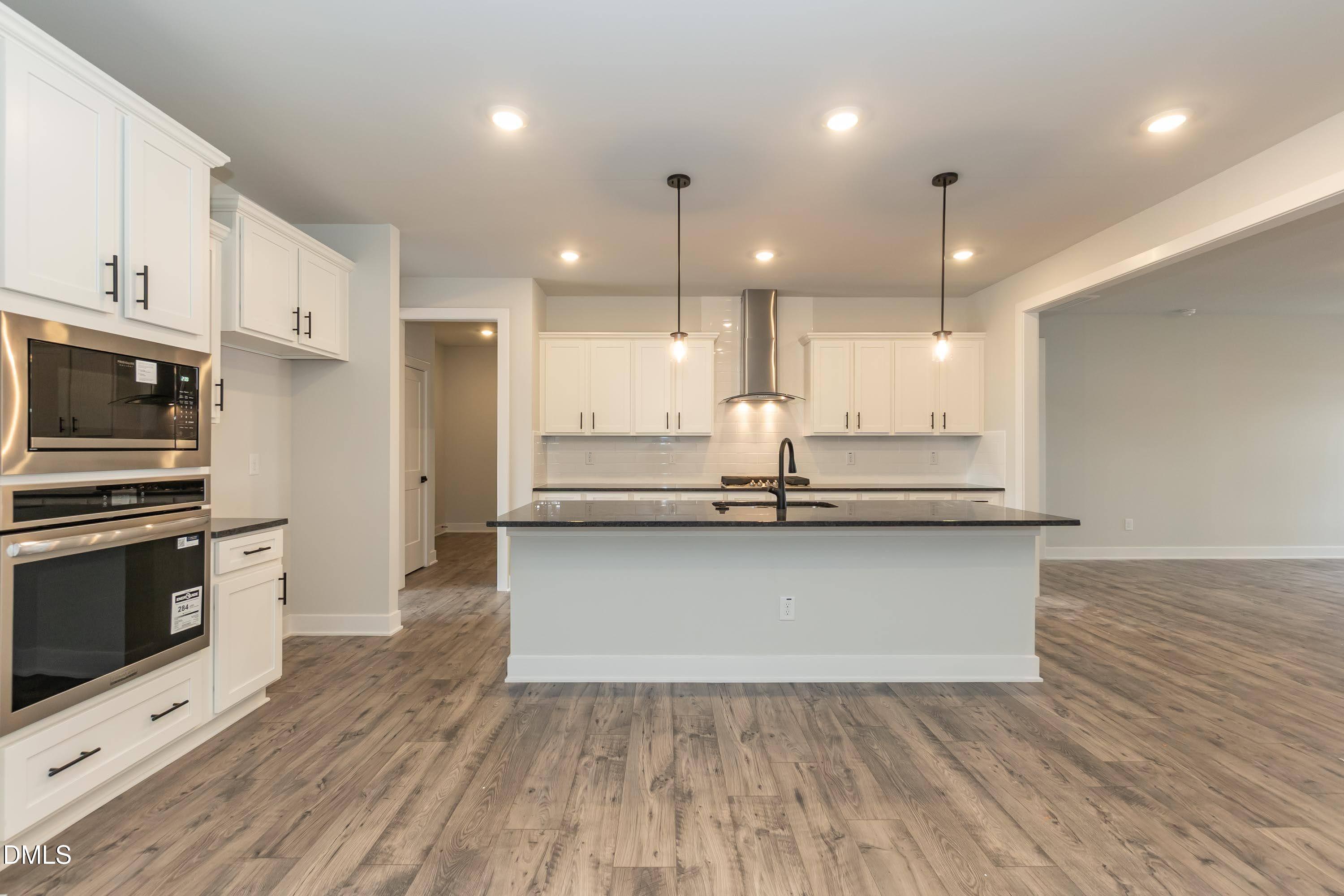 104 Galway Road Lillington, NC 27546 - Photo 11 of 40 a kitchen with kitchen island a sink and a stove