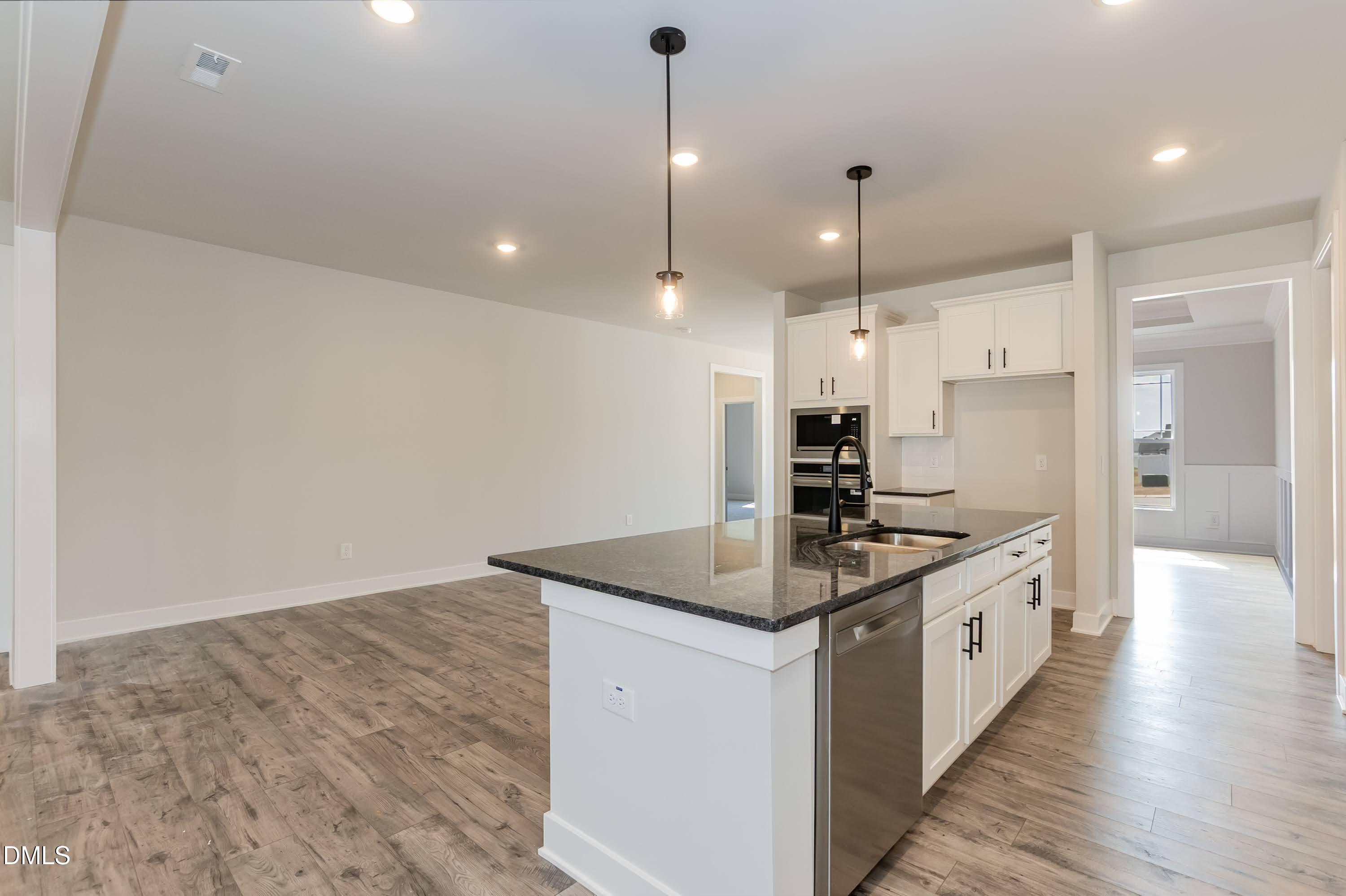104 Galway Road Lillington, NC 27546 - Photo 12 of 40 a kitchen with kitchen island a sink stainless steel appliances and white cabinets