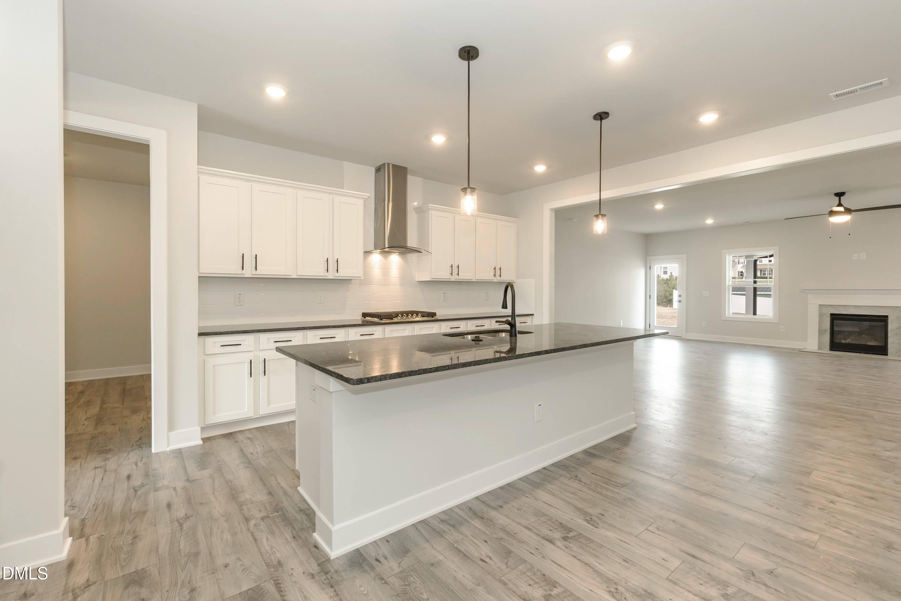 104 Galway Road Lillington, NC 27546 - Photo 13 of 40 a large kitchen with stainless steel appliances granite countertop a sink a stove and a refrigerator