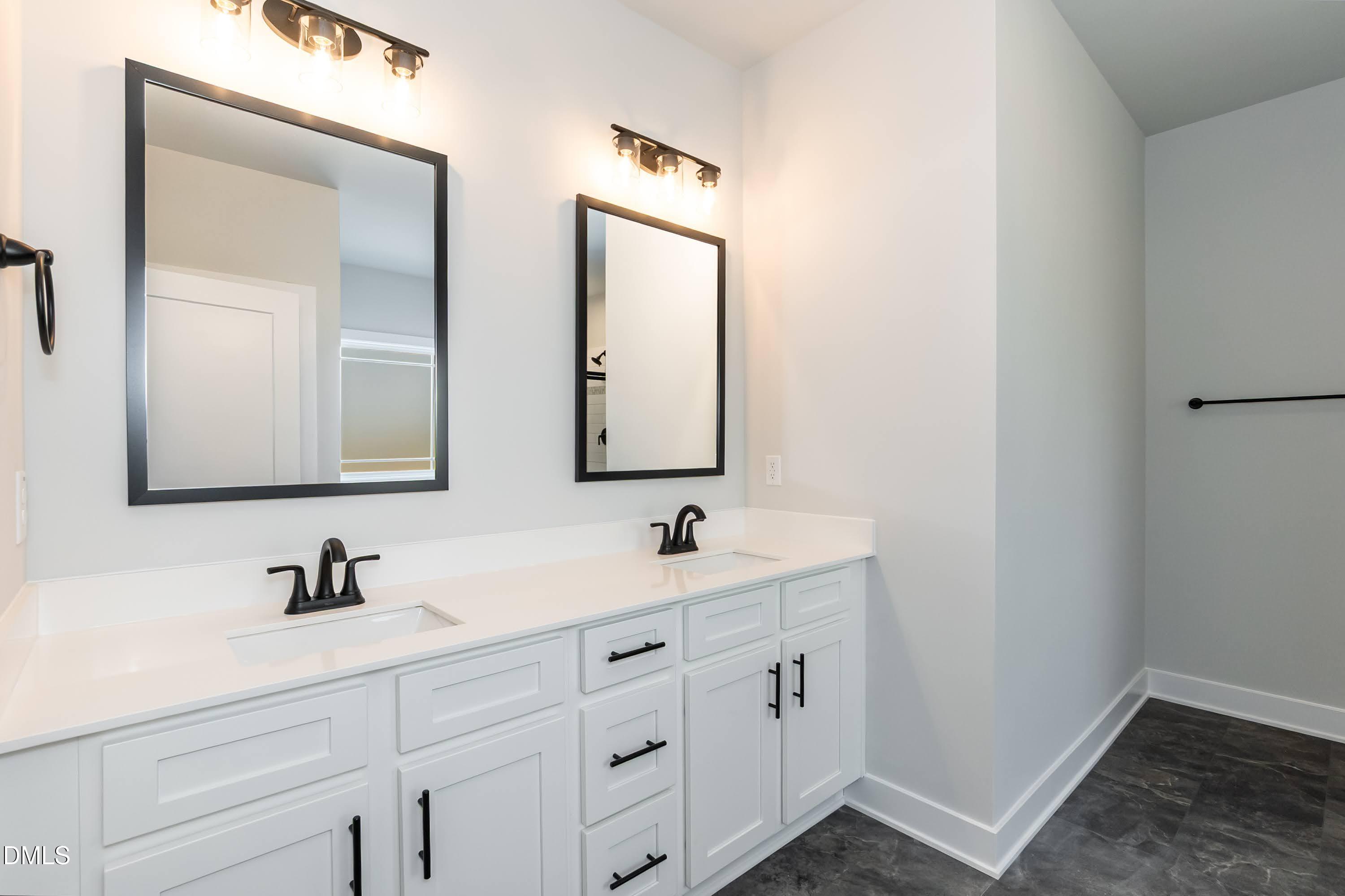 104 Galway Road Lillington, NC 27546 - Photo 22 of 40 a bathroom with 2 sink and a mirror