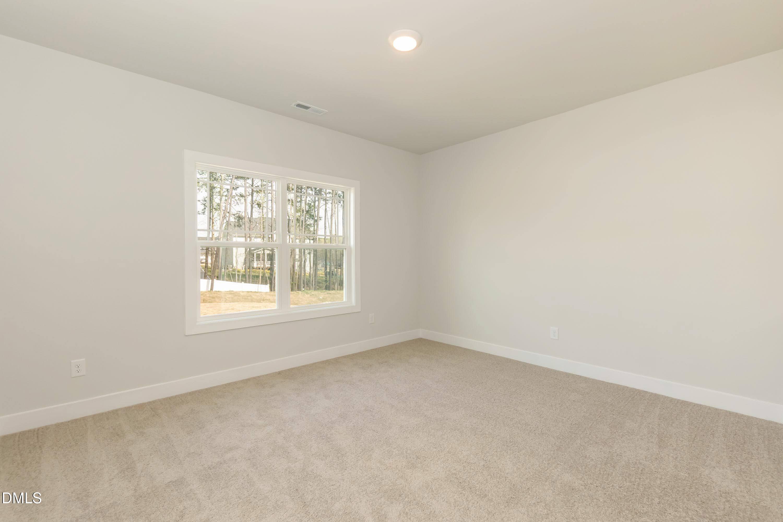104 Galway Road Lillington, NC 27546 - Photo 28 of 40 an empty room with a window