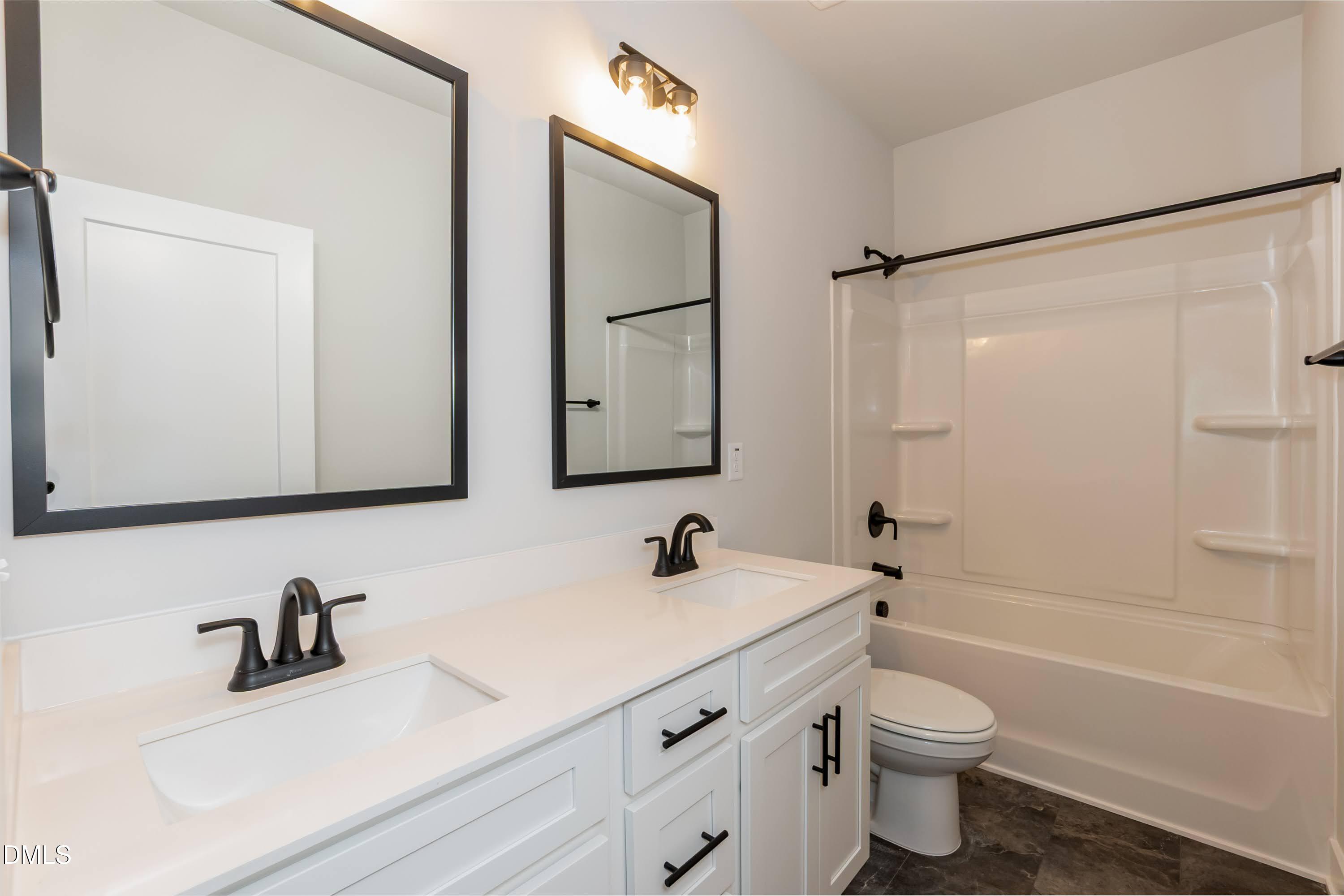 104 Galway Road Lillington, NC 27546 - Photo 29 of 40 a bathroom with a sink vanity toilet and shower