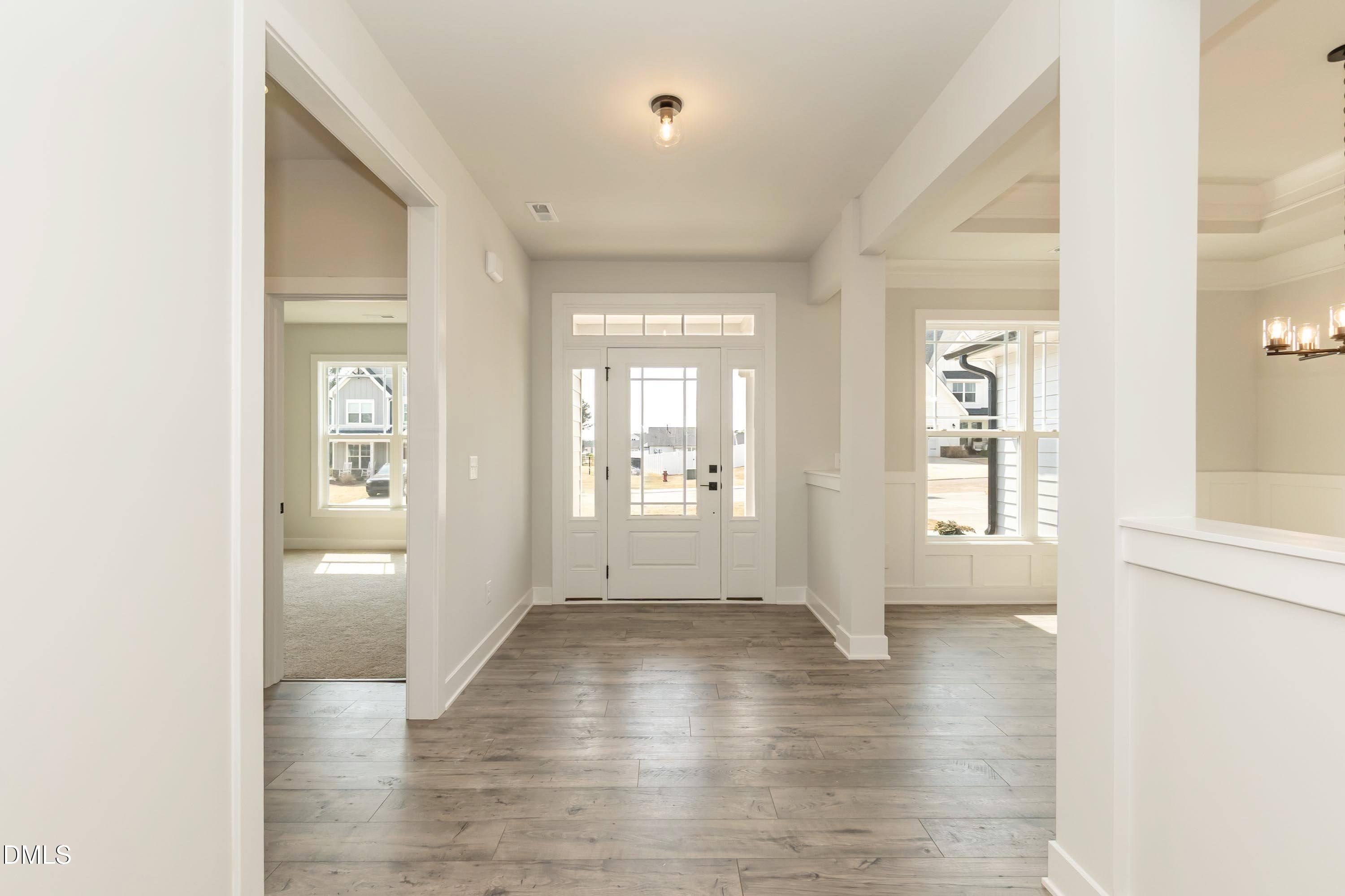 104 Galway Road Lillington, NC 27546 - Photo 7 of 40 a view of an empty room with window and wooden floor