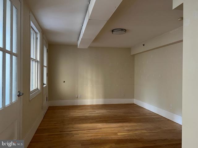 1615 Walnut Street, Unit 4 Philadelphia, PA 19102 - Photo 15 of 22 a view of room with window and wooden floor