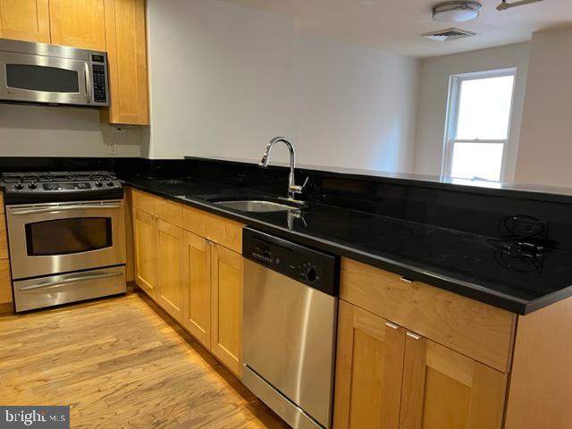 1615 Walnut Street, Unit 4 Philadelphia, PA 19102 - Photo 5 of 22 a kitchen with granite countertop a sink and a stove