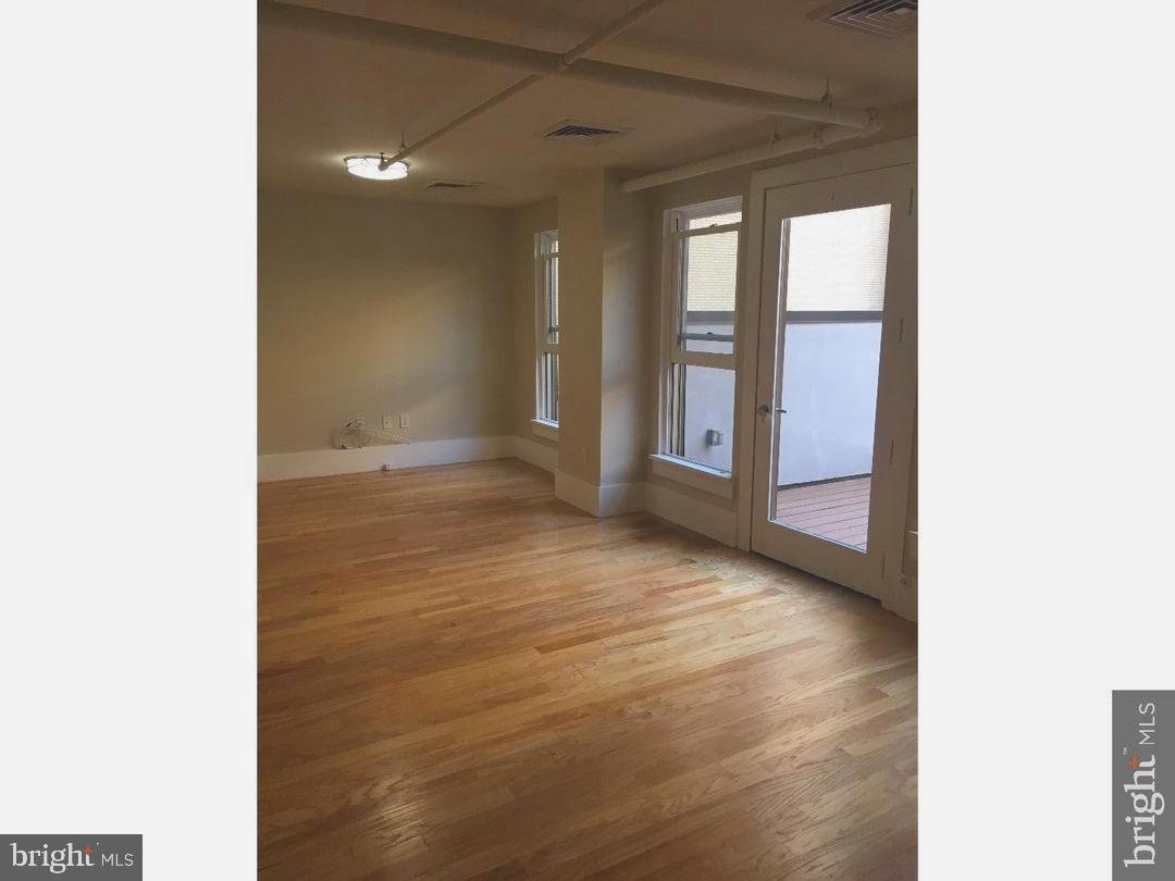 1615 Walnut Street, Unit 4 Philadelphia, PA 19102 - Photo 8 of 22 a view of an empty room with glass door