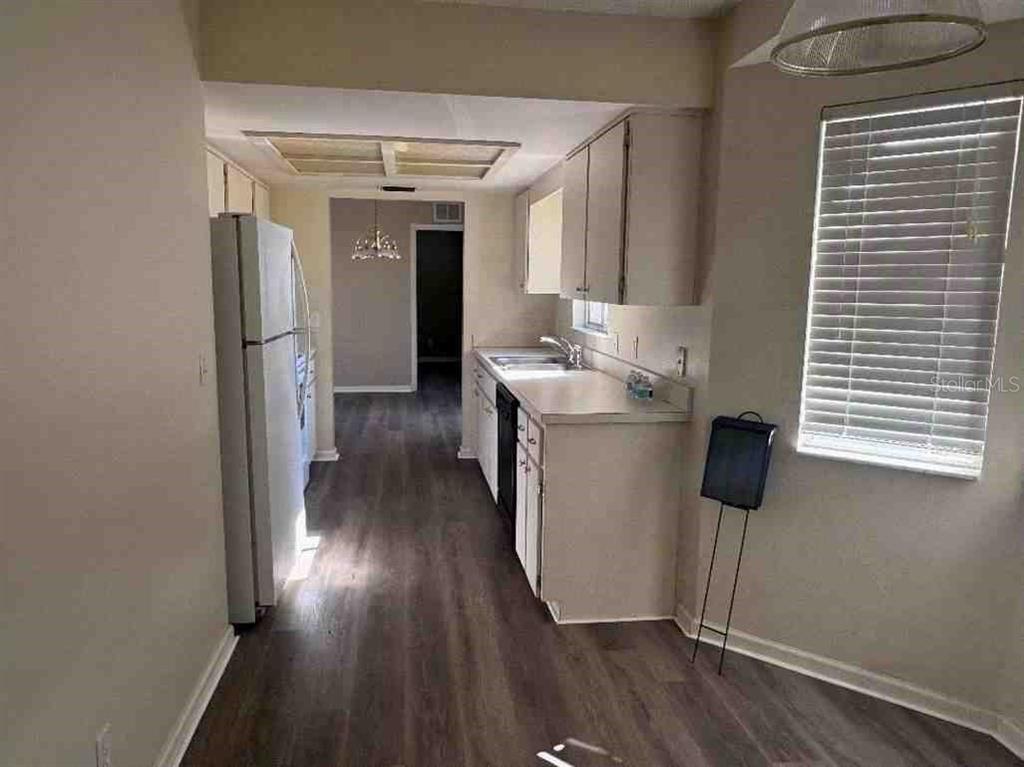 5110 Northwest 19th Place Ocala, FL 34482 - Photo 4 of 9 a kitchen with a sink and wooden floor