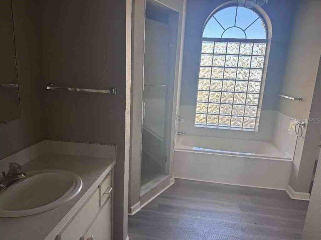 5110 Northwest 19th Place Ocala, FL 34482 - Photo 6 of 9 a bathroom with a tub a sink and a shower