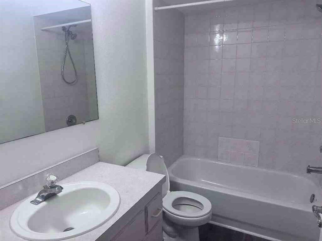 5110 Northwest 19th Place Ocala, FL 34482 - Photo 7 of 9 a bathroom with a sink toilet and shower